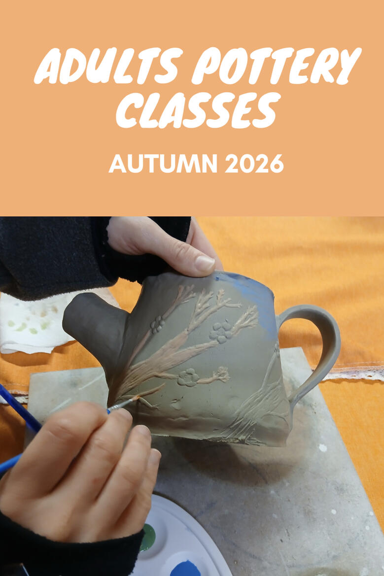 Adult Pottery Classes A hand painting a clay teapot during a pottery class