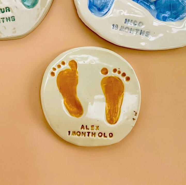 Baby Handprints Close up of a child's hand while painting a ceramic imprint of their own hand