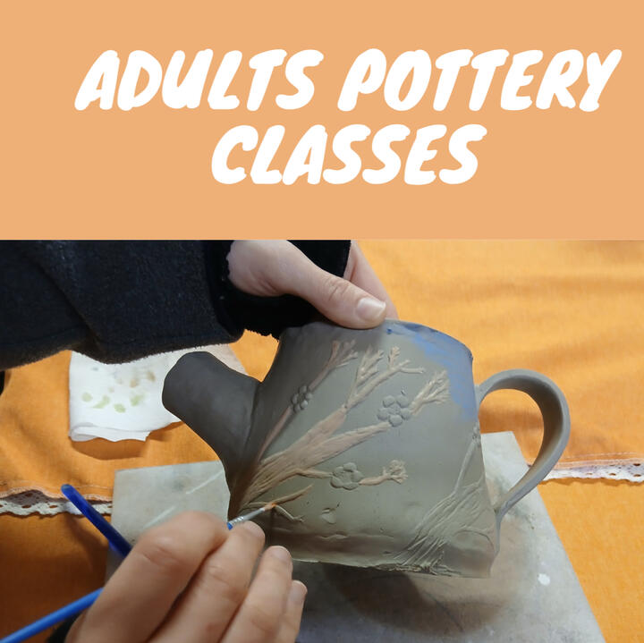 Painting Pottery A mother and her three child daughters smile while painting ceramic Christmas ornaments at a Paint-Your-Own-Pottery pieces
